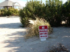 photo of sign covered in sand